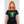 Load image into Gallery viewer, A woman wearing the Digiskull shirt that depicts a bright green deteriorating skull floating in the middle of a grid matrix on a black shirt.