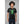 Load image into Gallery viewer, A man wearing the Digiskull shirt that depicts a bright green deteriorating skull floating in the middle of a grid matrix on a black shirt.