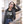 Load image into Gallery viewer, A young cool woman wearing a leather jacket and the Hombre Lobo shirt that depicts an abstract werewolf face.