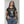 Load image into Gallery viewer, A cool young woman wearing a black Cobra Boss shirt that depicts a colorful 8 bit cobra and the words Game Over.