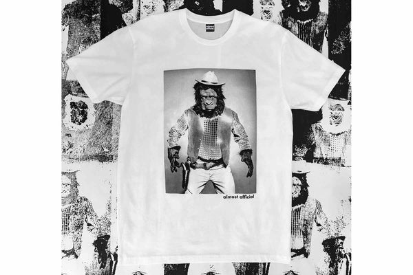 The High Noon white shirt depicting a cowboy gorilla on a screen printed poster background.