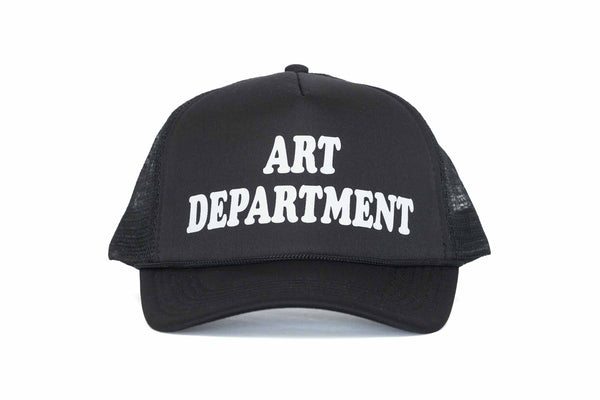 The front of a black trucker hat with the text Art Department printed in white.