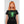 Load image into Gallery viewer, A woman wearing the Digiskull shirt that depicts a bright green deteriorating skull floating in the middle of a grid matrix on a black shirt.
