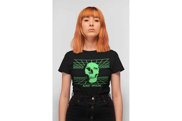 A woman wearing the Digiskull shirt that depicts a bright green deteriorating skull floating in the middle of a grid matrix on a black shirt.