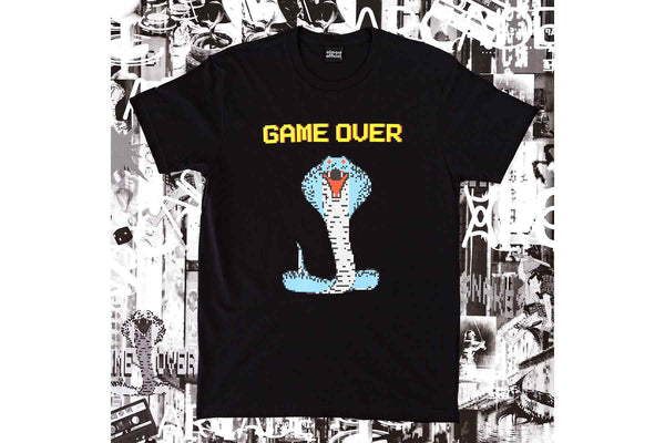 The Cobra Boss shirt depicting a colorful 8 bit cobra and the words Game Over printed on a black shirt with a detailed poster background.